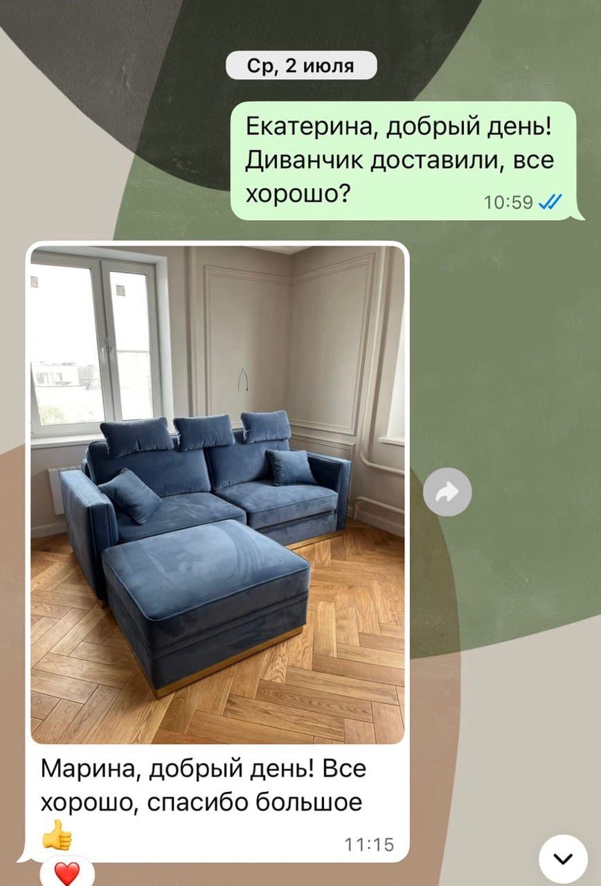 Синий велюровый диван с пуфом и подушками в комнате с ёлочкой-паркетом и высокими окнами
